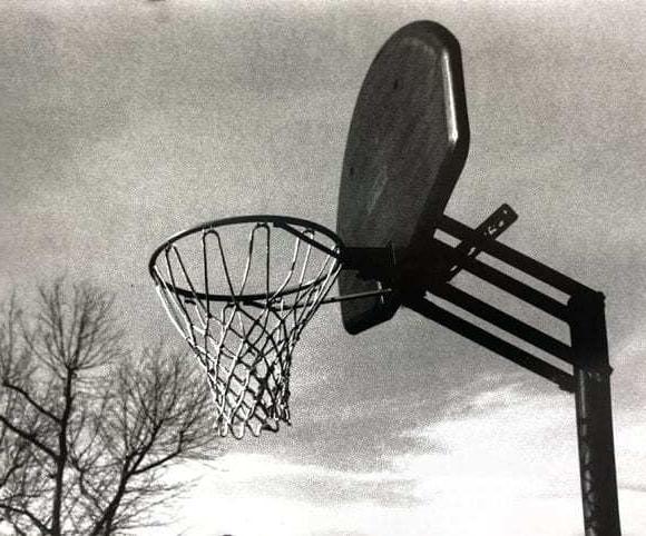 Black and white image of a basketball net